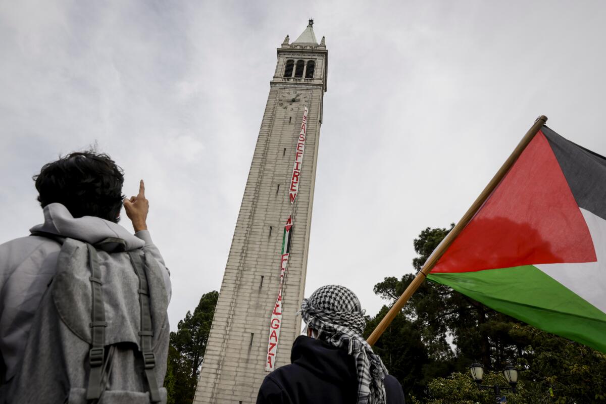 A banner calling for a cease-fire hangs from UC Berkeley's Sather Tower.