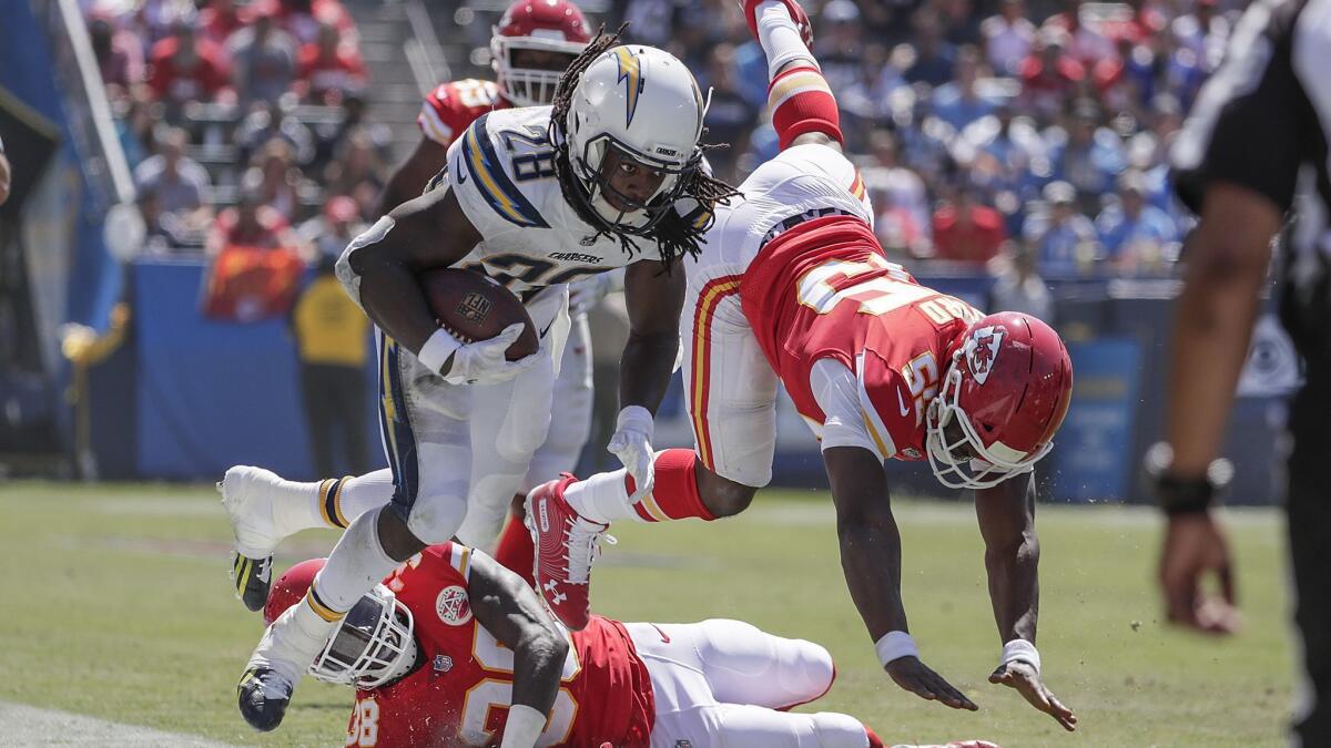Chargers running back Melvin Gordon is forced out of bounds by Kansas City Chiefs defenders after a first-half run at StubHub Center.