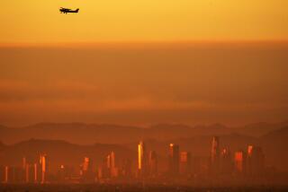 LONG BEACH, CALIF. - SEPT. 1, 2022. The downtown Los Angeles skyline shimmers in the smog as a plane taking off from Long Beach Airport climbs out of the haze after another hot day across Southern California. A brutal heatwave is expected to last through. the Labor Day weekend. (Luis Sinco /. Los Angeles Times)