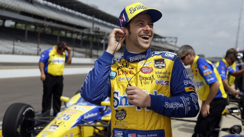 Marco Andretti standing in front of his car