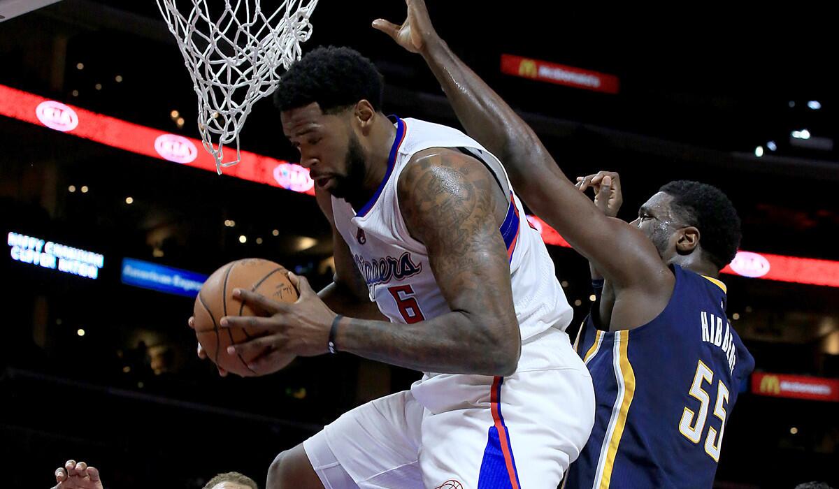 Clippers center DeAndre Jordan pulls down a rebound in front of Pacers center Roy Hibbert in the first half.