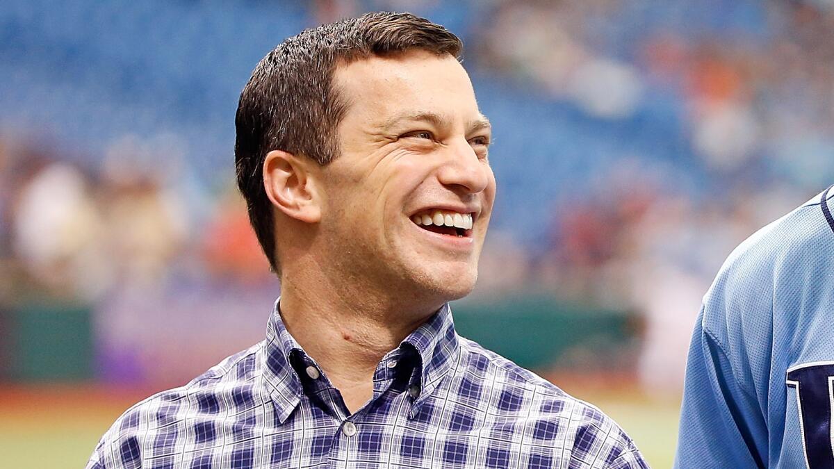Former Tampa Bay Rays general manager Andrew Friedman was hired Tuesday to head the Dodgers' baseball operations department.