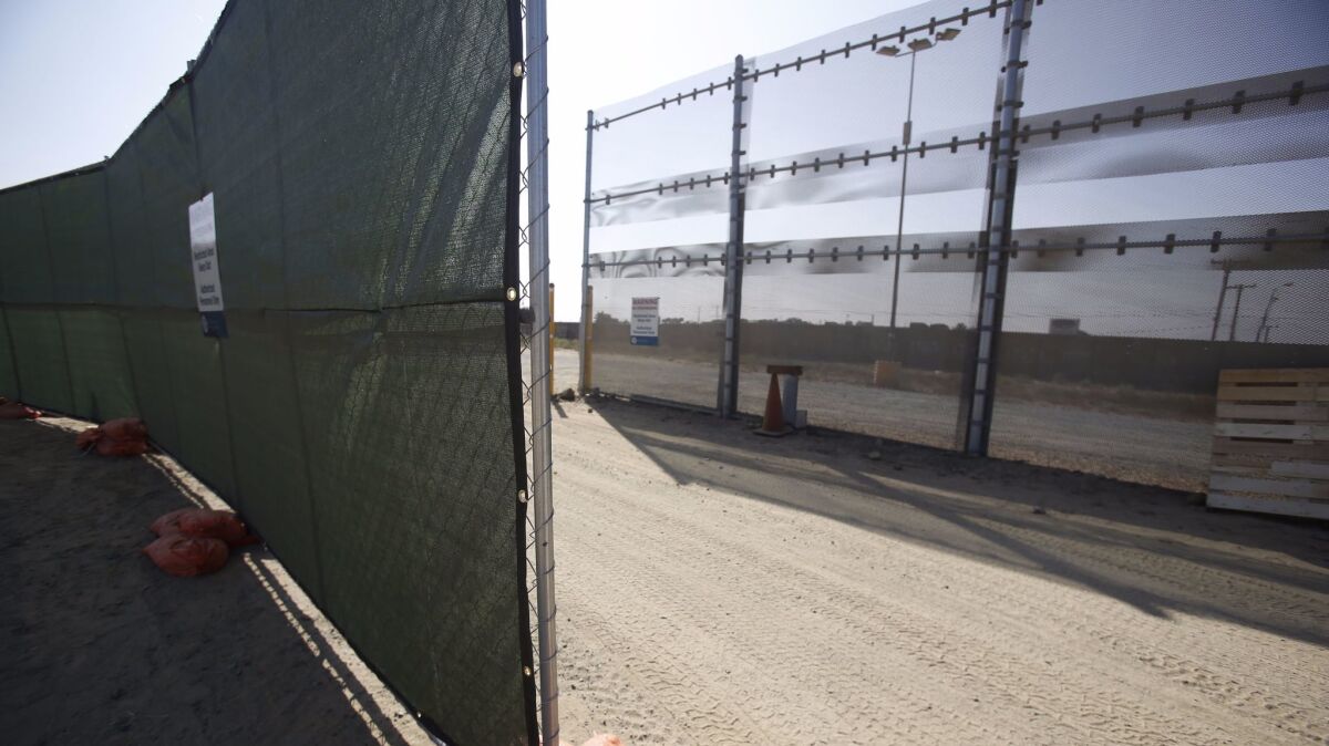 Fencing stands in the Otay Mesa area of San Diego where border wall prototypes are to be constructed.