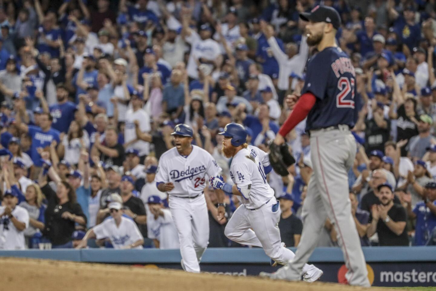 As Red Sox pitcher Rick Porcello watches, Dodger Justin Turner doubles in the third inning.