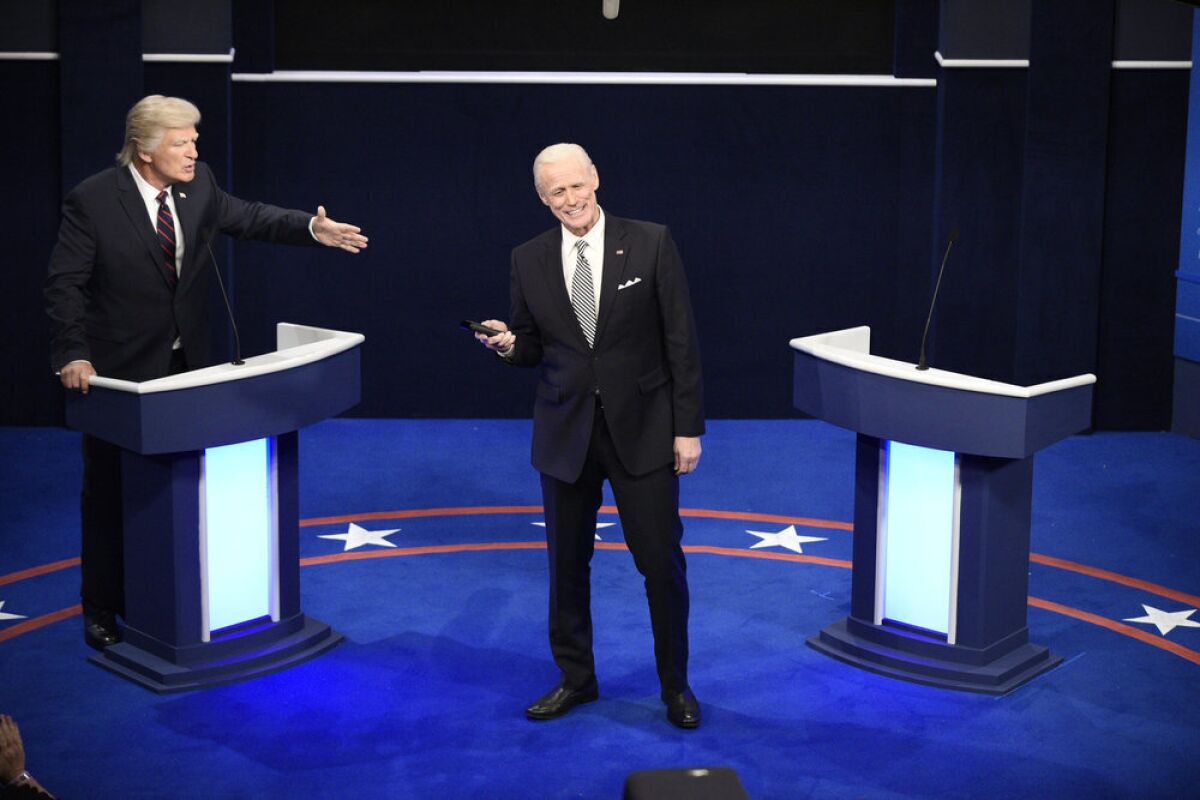 This image released by NBC shows Alec Baldwin as Donald Trump, left, and Jim Carrey as Joe Biden during the "First Debate" Cold Open on "Saturday Night Live" in New York on Oct. 3, 2020. (Will Heath/NBC via AP)