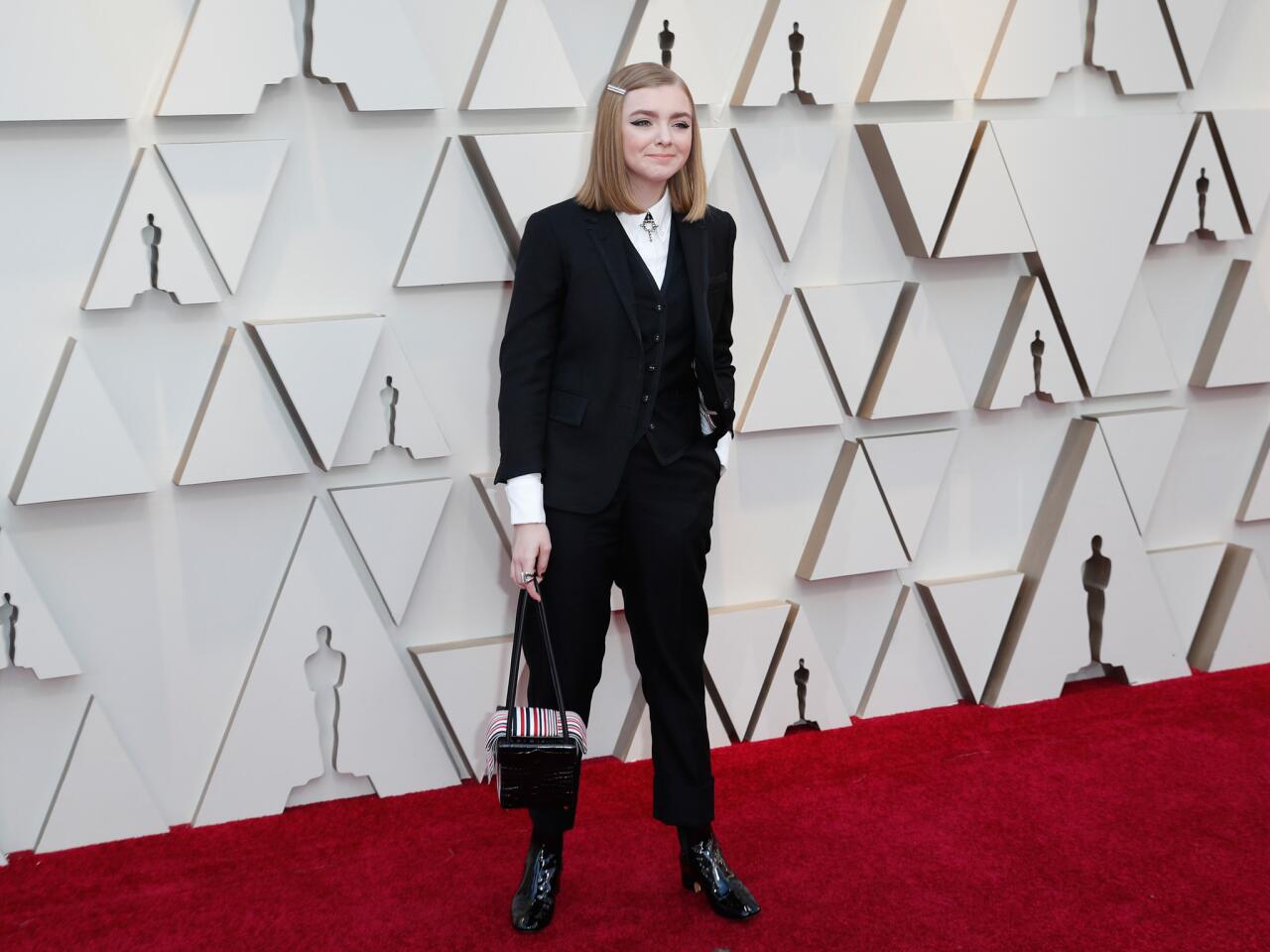 HIT: Elsie Fisher brings a touch of gender-bending to the carpet courtesy of a Thom Browne suit and laced-up platform boots.