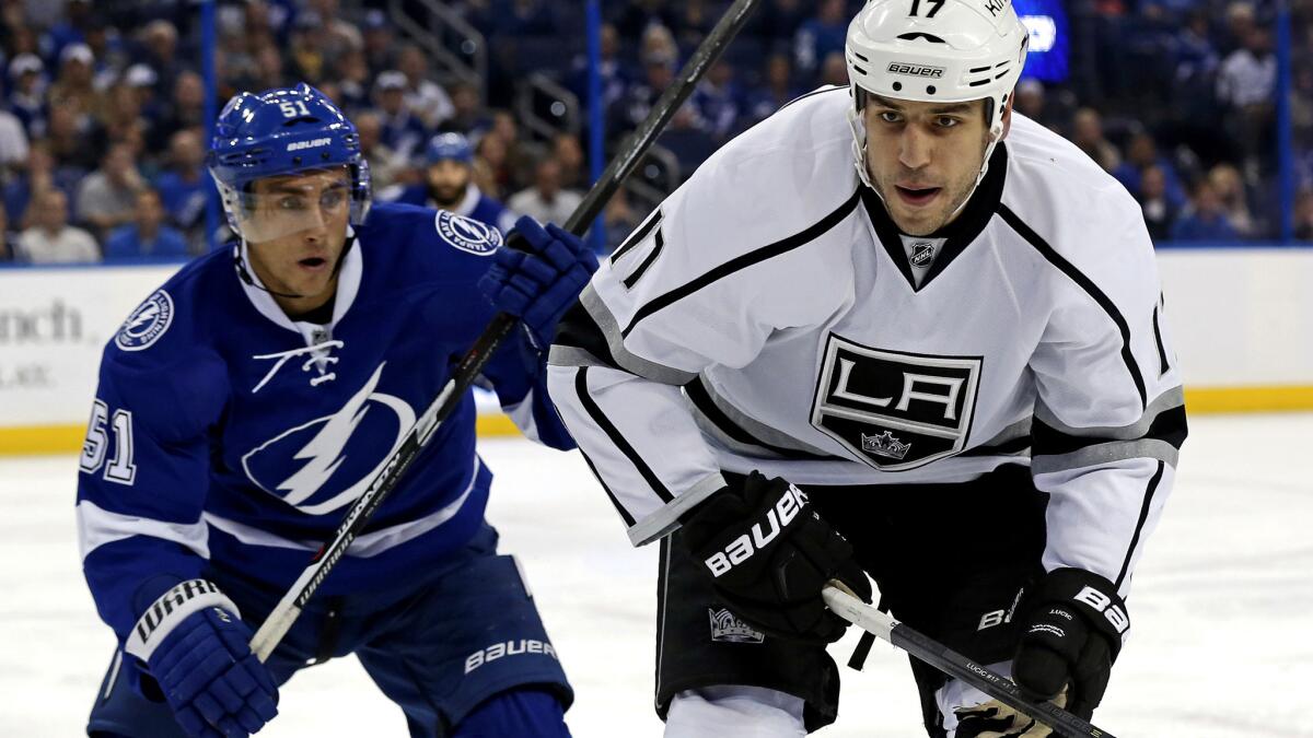 Kings winger Milan Lucic, right, beats the Tampa Bay Lightning's Valtteri Filppula to a loose puck in the first period Wednesday night.