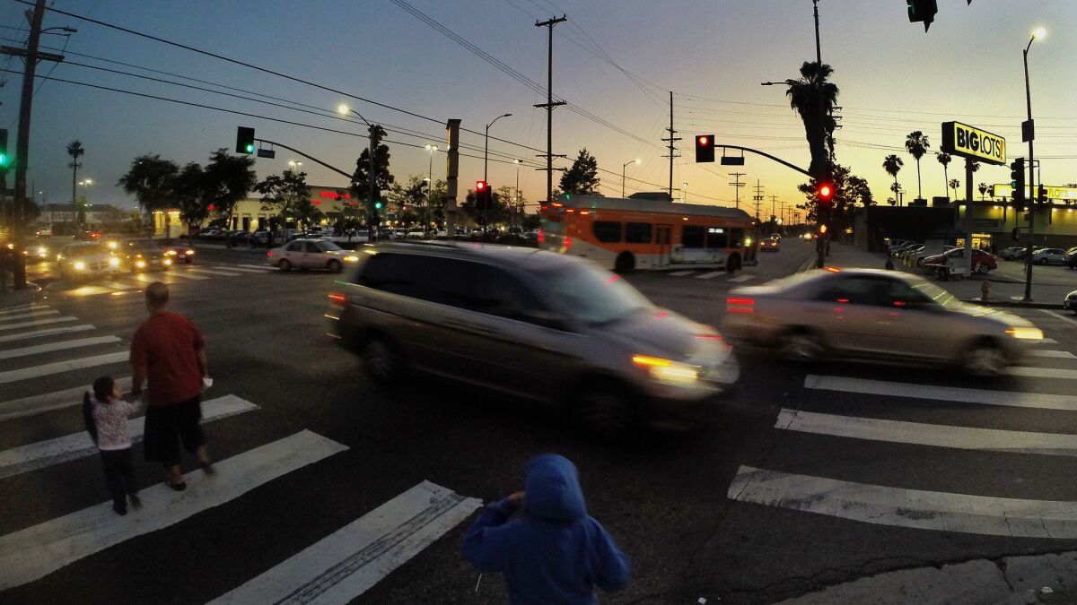 Pedestrians cross at the intersection of Slauson and Western Avenues in Los Angeles on April 14, 2015.