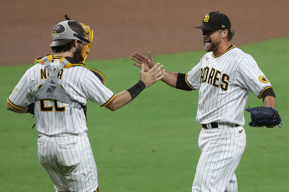 The Padres' Trevor Rosenthal celebrates a game and series win against the St. Louis Cardinals with Austin Nola