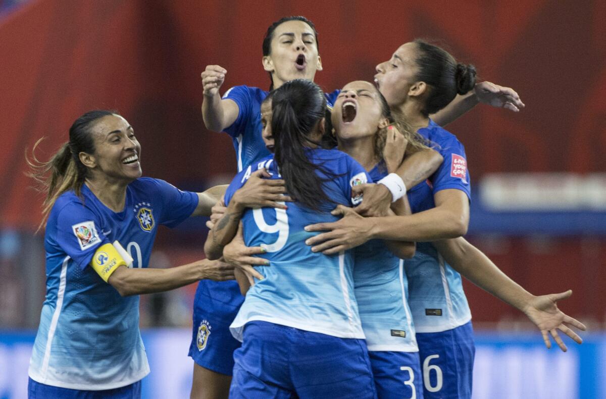 Andrressa Alves (9) is surrounded by her Brazil teammates after scoring a goal against Spain during the first half of a Women's World Cup game Saturday in Montreal.