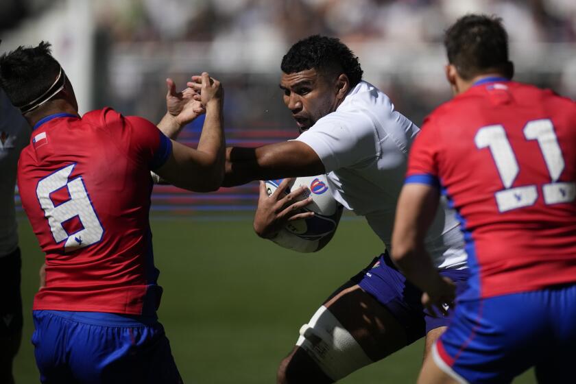Samoa's Taleni Junior Agaese Seu, center, fight for the ball with Chile's Raimundo Martinez, 8, during the Rugby World Cup Pool D match between Samoa and Chile at the Stade de Bordeaux in Bordeaux, France, Saturday, Sept. 16, 2023. (AP Photo/Christophe Ena)
