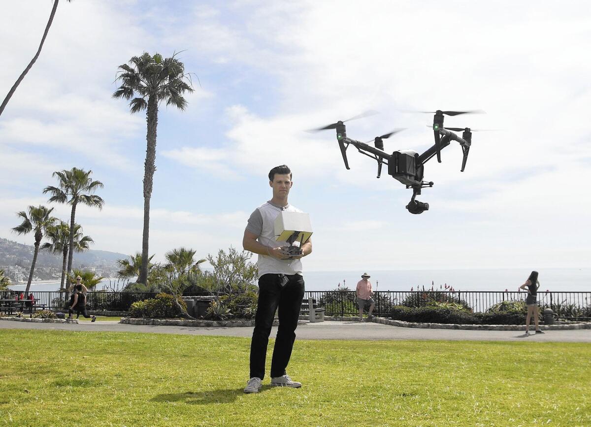 Licensed drone pilot John Barrett flies his professional model camera drone at Heisler Park in Laguna Beach on Friday.