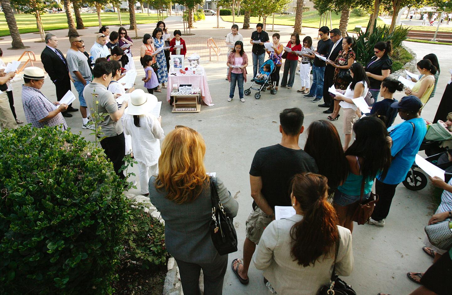 Attendees form a circle and recite a prayer at a prayer vigil for missing FBI agent Stephen Ivens at McCambridge Park in Burbank.