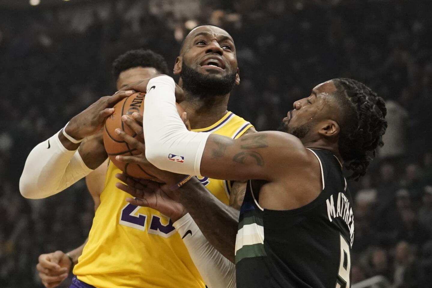 Bucks guard Wesley Matthews wraps up Lakers forward LeBron James during the first half of a game Dec. 19.