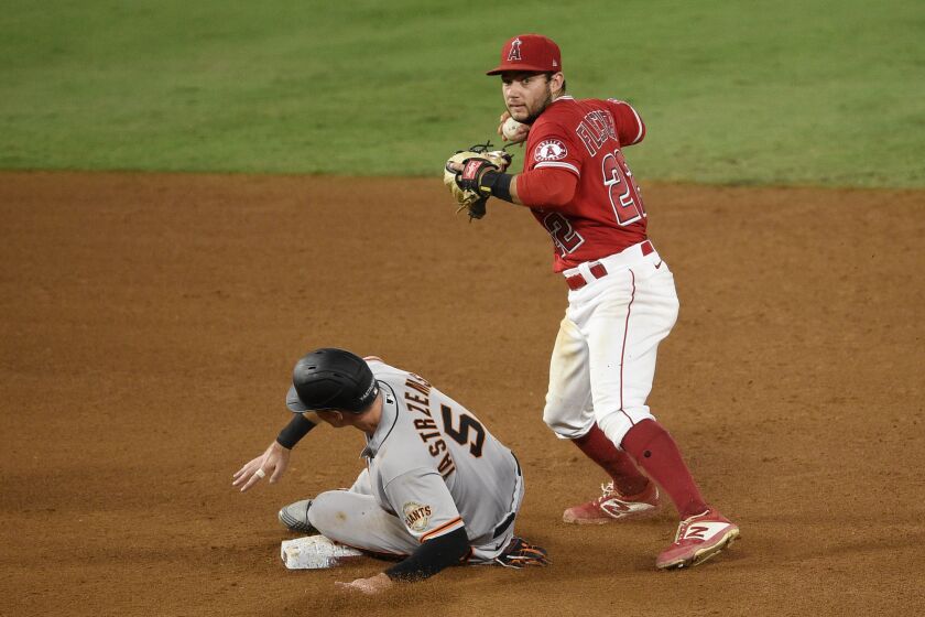 Los Angeles Angels shortstop David Fletcher, right, forces out San Francisco Giants' Mike Yastrzemski off an RBI into fielder's choice by Alex Dickerson during the fifth inning of a baseball game in Anaheim, Calif., Monday, Aug. 17, 2020. (AP Photo/Kelvin Kuo)