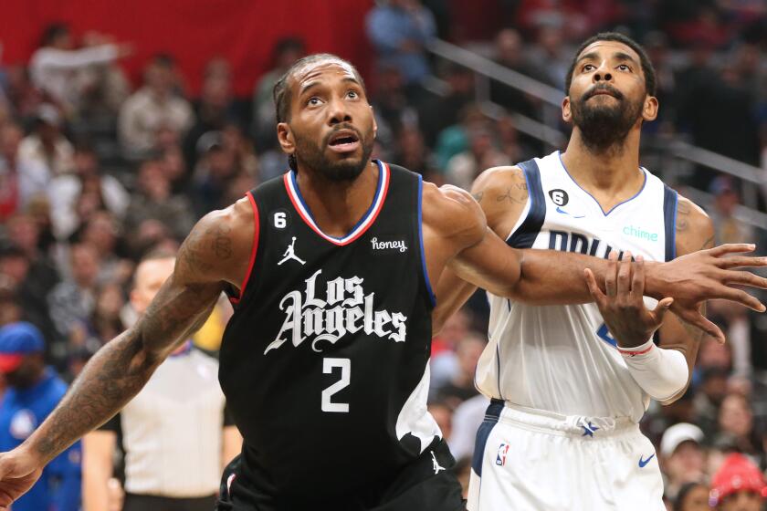 LOS ANGELES, CA - FEBRUARY 08: Clippers Kawhi Leonard and Mavericks Kyrie Irving during the Clippers and Dallas Mavericks game at Crypto.com Arena on Wednesday, Feb. 8, 2023. (Myung J. Chun / Los Angeles Times)