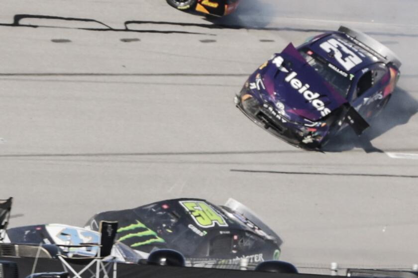 NASCAR Cup Series driver Erik Jones (43) collides driver Bubba Wallace (23) during a NASCAR Cup Series auto race at Talladega Superspeedway, Sunday, April 21, 2024, in Talladega. Ala. (AP Photo/Russell Norris)