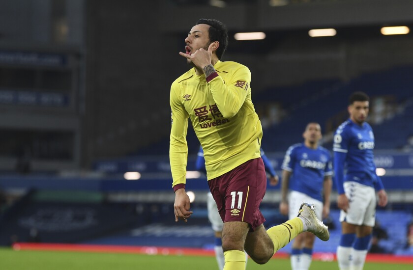 Burnley's Dwight McNeil celebrates after scoring his side's second goal duels for the ball with during the English Premier League soccer match between Everton and Burnley at Goodison Park in Liverpool, England, Saturday, March 13, 2021. (Gareth Copley/Pool via AP)