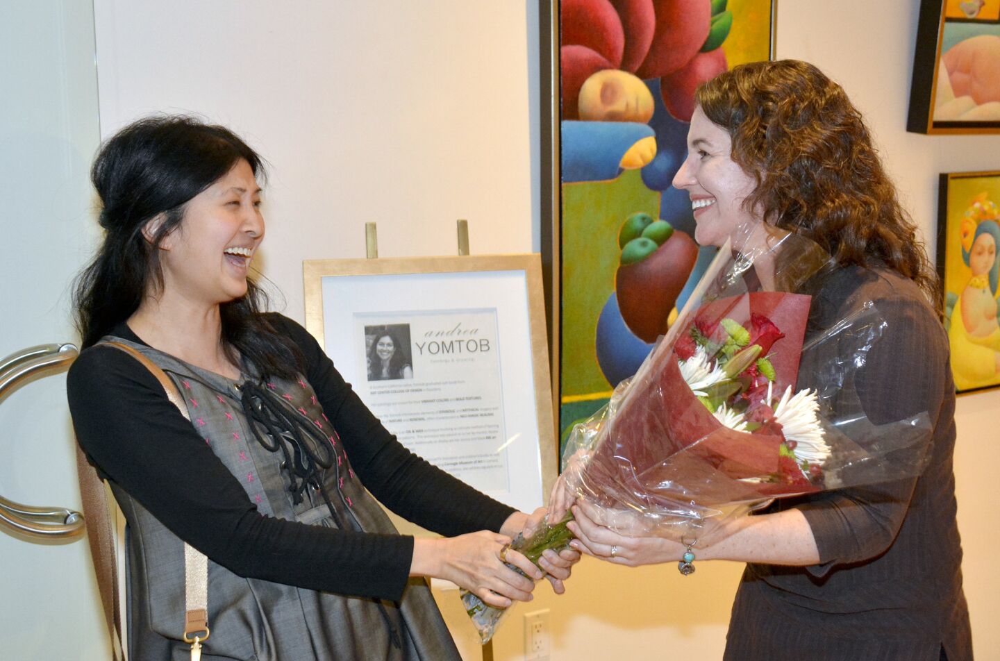 Artist Andrea Yomtob, left, is congratulated by her former Nickelodeon colleague Amy Casler during the Friday evening opening of her exhibit at Gallery 839.