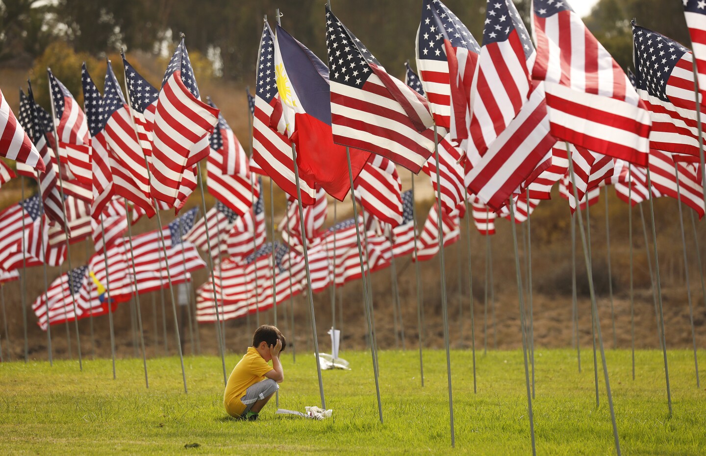 MALIBU, CA - SEPTEMBER 11, 2019 7-year-old Alex Pitz came with his Mother Heather to visit Pepperdine University’s annual Waves of Flags installation that commemorates the 2,977 lives lost in the 9/11 terror attacks. Heather who is originally from the East Coast has family members who saw the attacks first hand and wants here son to know about the history. This is the 12th consecutive installation and features a display of 2,887 American flags for each American life lost and 90 international flags representing the home countries of those from abroad. (Al Seib / Los Angeles Times)