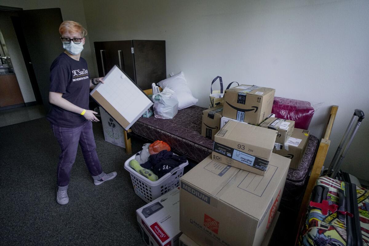 Grayson Henard, from Fresno, unpacks his belongings at the Tower dormitory at UCSD.