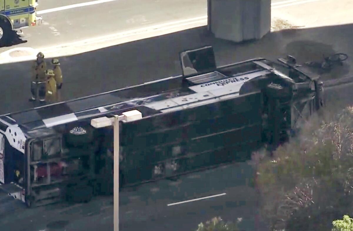 A bus lies on its side after a crash