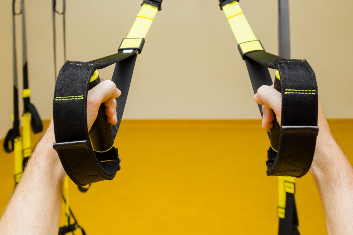 Using TRX suspension cables can help with foundational exercises to prepare you for pullups.