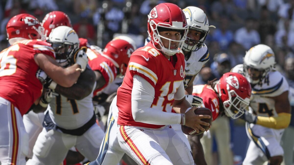 Kansas City quarterback Patrick Mahomes looks over his shoulder on an option play against the Chargers on Sept. 9.