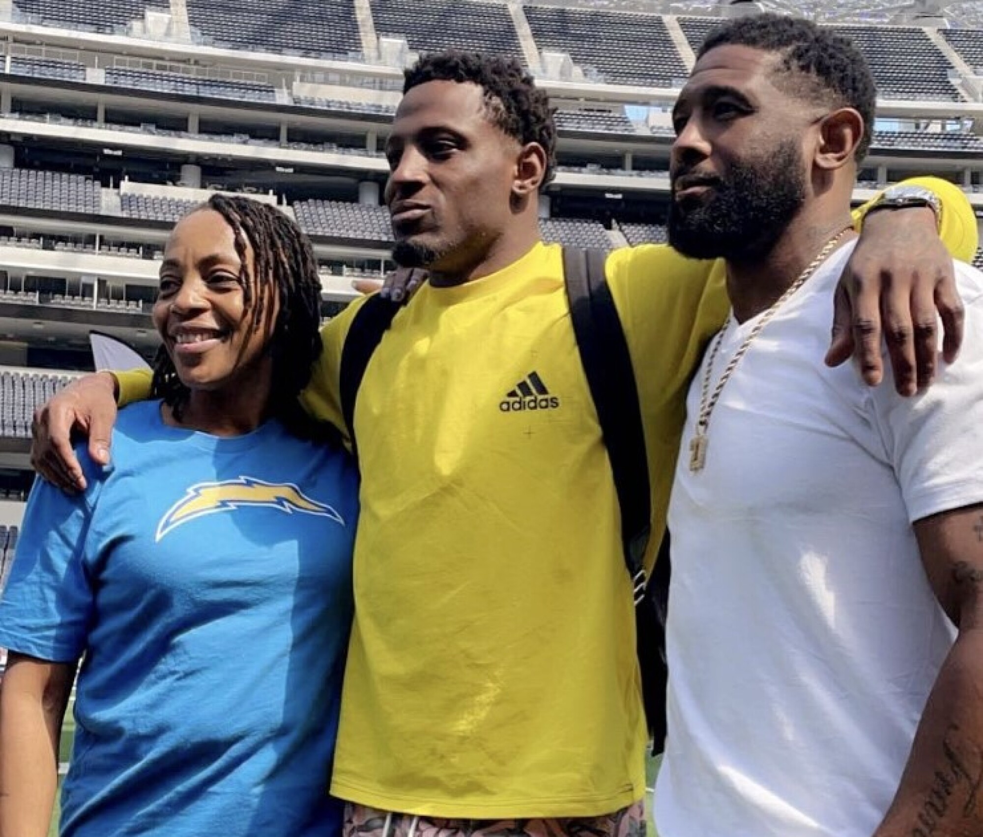 J.C. Jackson and his mom, Lisa Dasher, and dad, Chris Jackson, stand with their son after he signed with the Chargers.