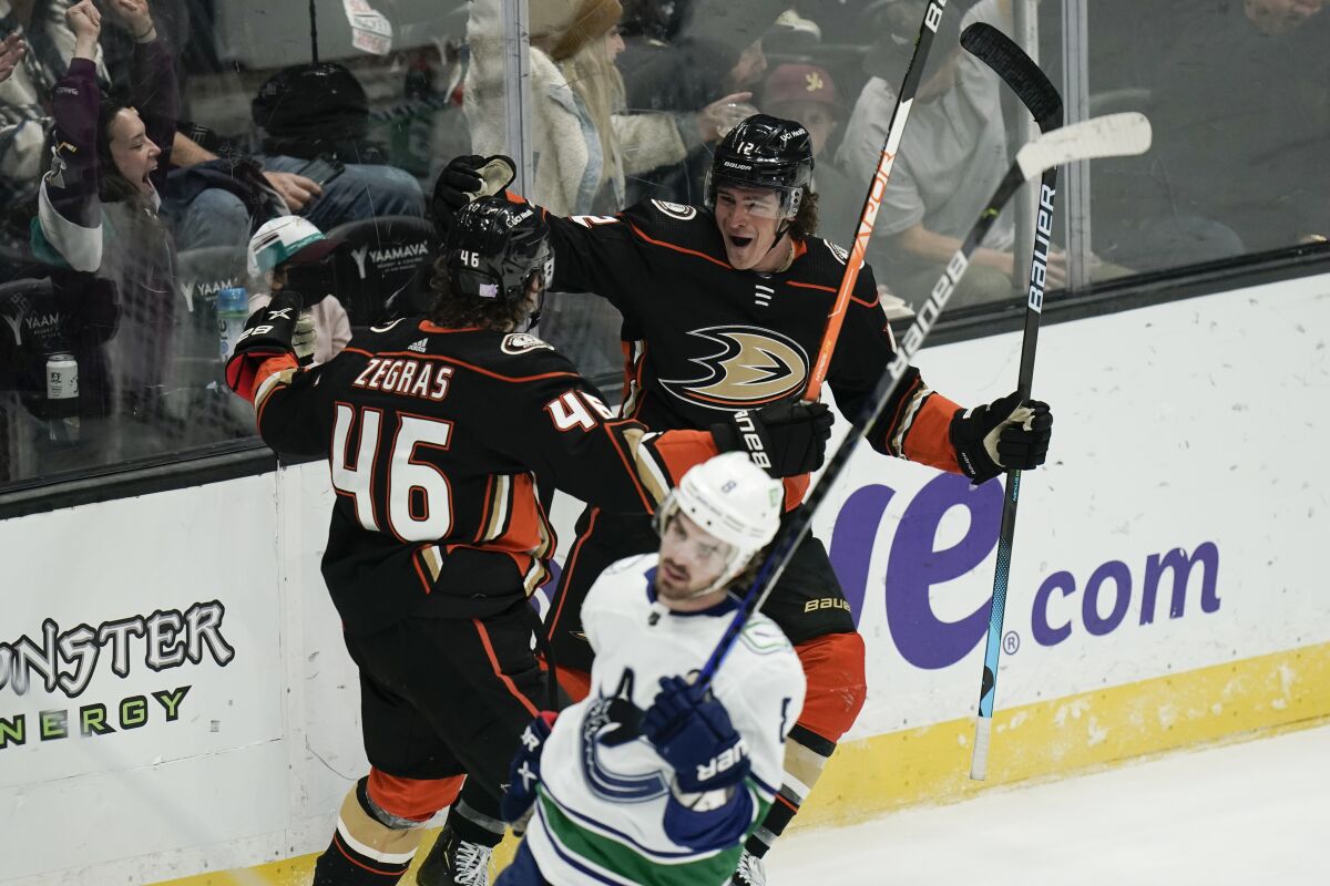 Ducks forward Sonny Milano, right, celebrates with Trevor Zegras after scoring in a 5-1 win over the Vancouver Canucks.