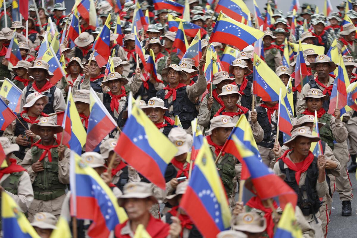Members of the militias march during a commemoration
