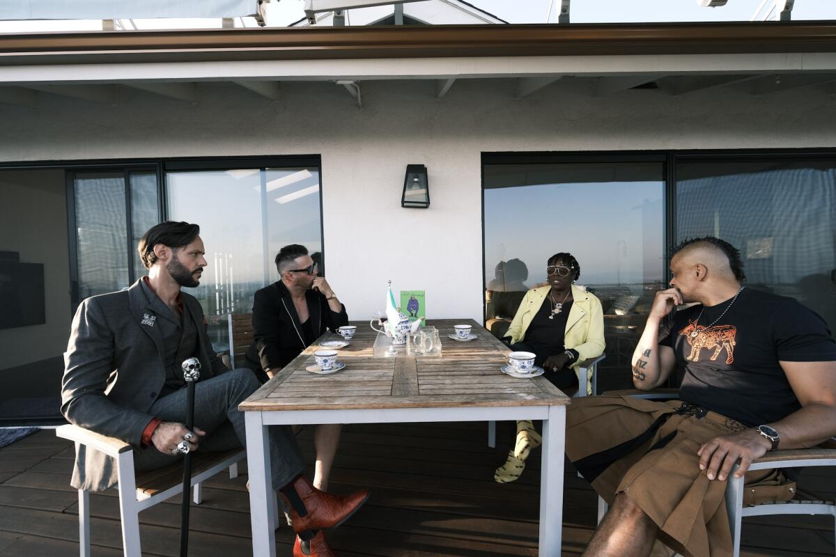 Leach, Graham, Yashere and Tonderai sitting in the backyard at Yashere's home.