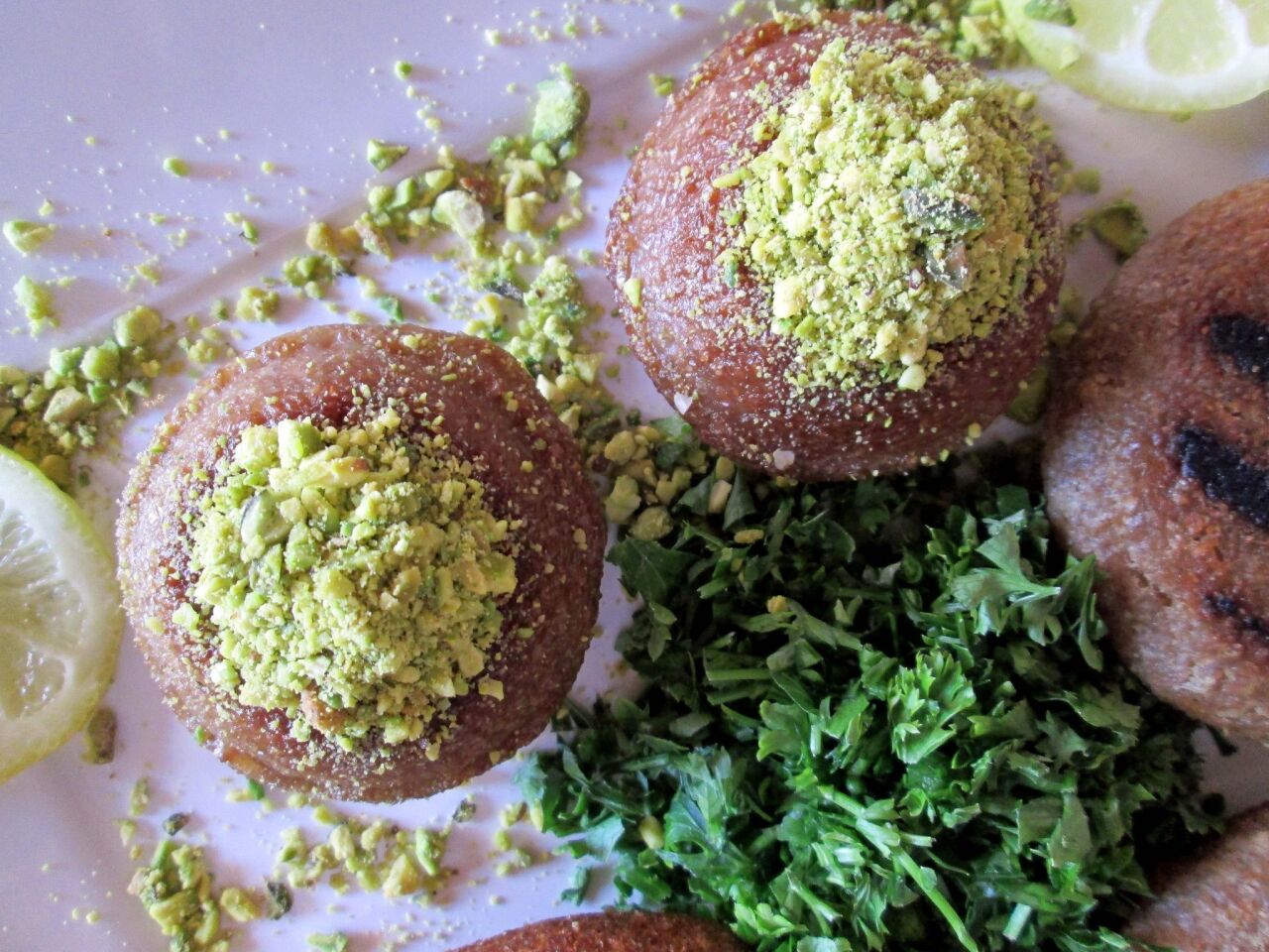 Kibbeh is topped with pistachios.