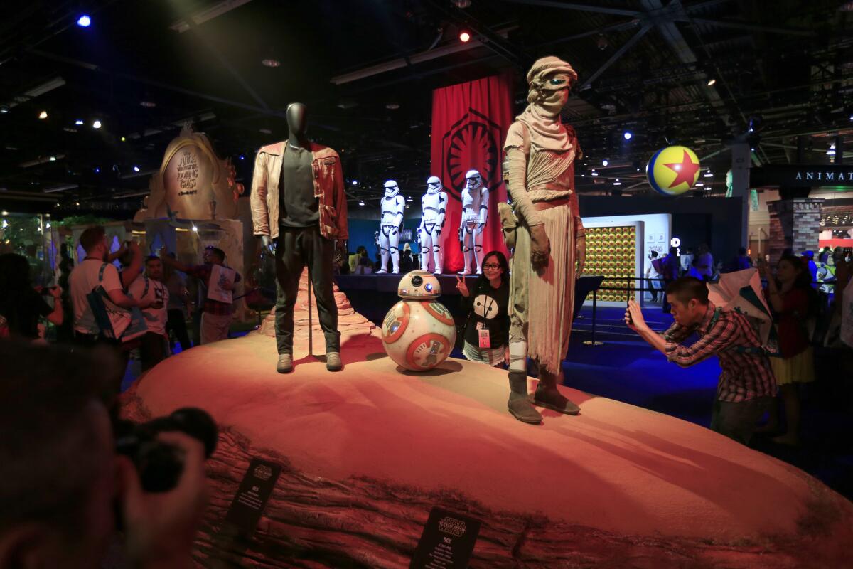 ANAHEIM, CALIF. -- FRIDAY, AUGUST 14, 2015: Finn, left, BB-8, and Rey, characters from the upcoming Star Wars The Force Awakens are on display at Disney's D23 at the Anaheim Convention Center in Anaheim, Calif., on Aug. 14, 2015. (Allen J. Schaben / Los Angeles Times)