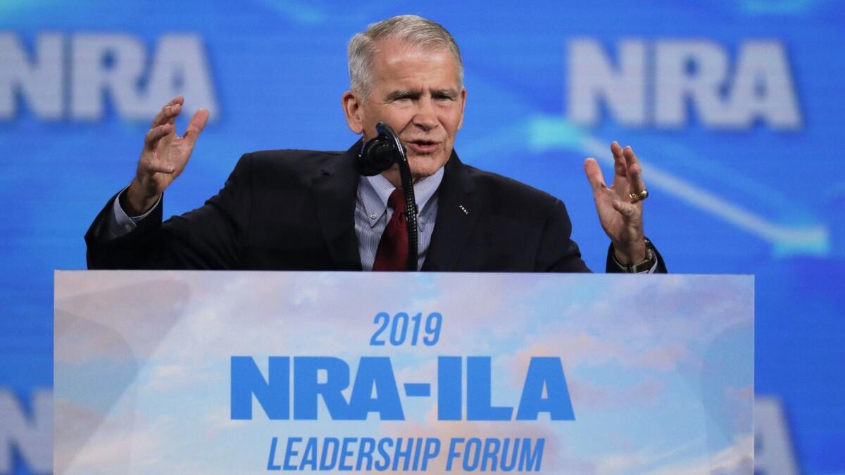Oliver North speaks at the National Rifle Assn. gathering in Indianapolis. He was not present when his statement was read announcing he was quitting as president.