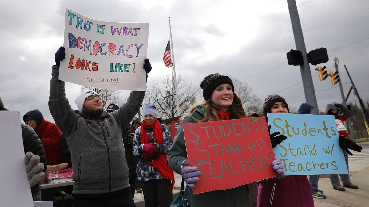 West Virginia teachers, students and supporters gather on a street in Morgantown to show their support for striking teachers, who are asking for pay raises.