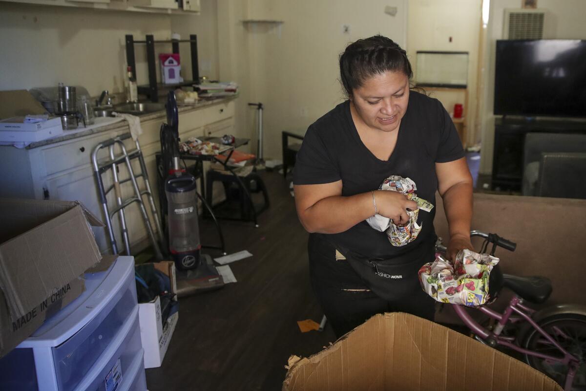 Juana Oceguera, 41, packs items in her apartment.