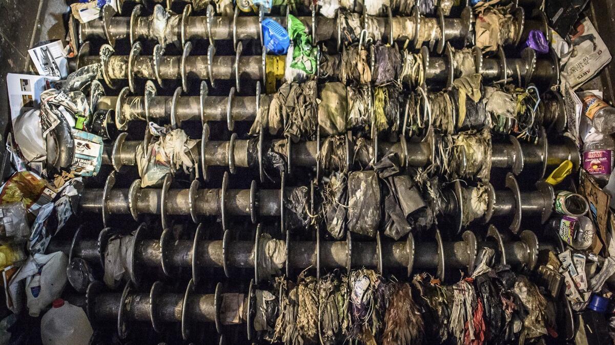 Plastic bags and containers jam a giant sorting machine at Materials Innovation and Recycling Authority in Connecticut.