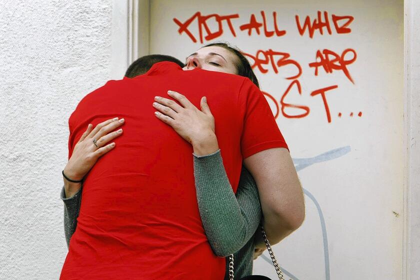 Hannah Maschwitz gets a hug from boyfriend Tyler Mullen as the two UC Santa Barbara seniors reunite Saturday morning near the rampage scene.