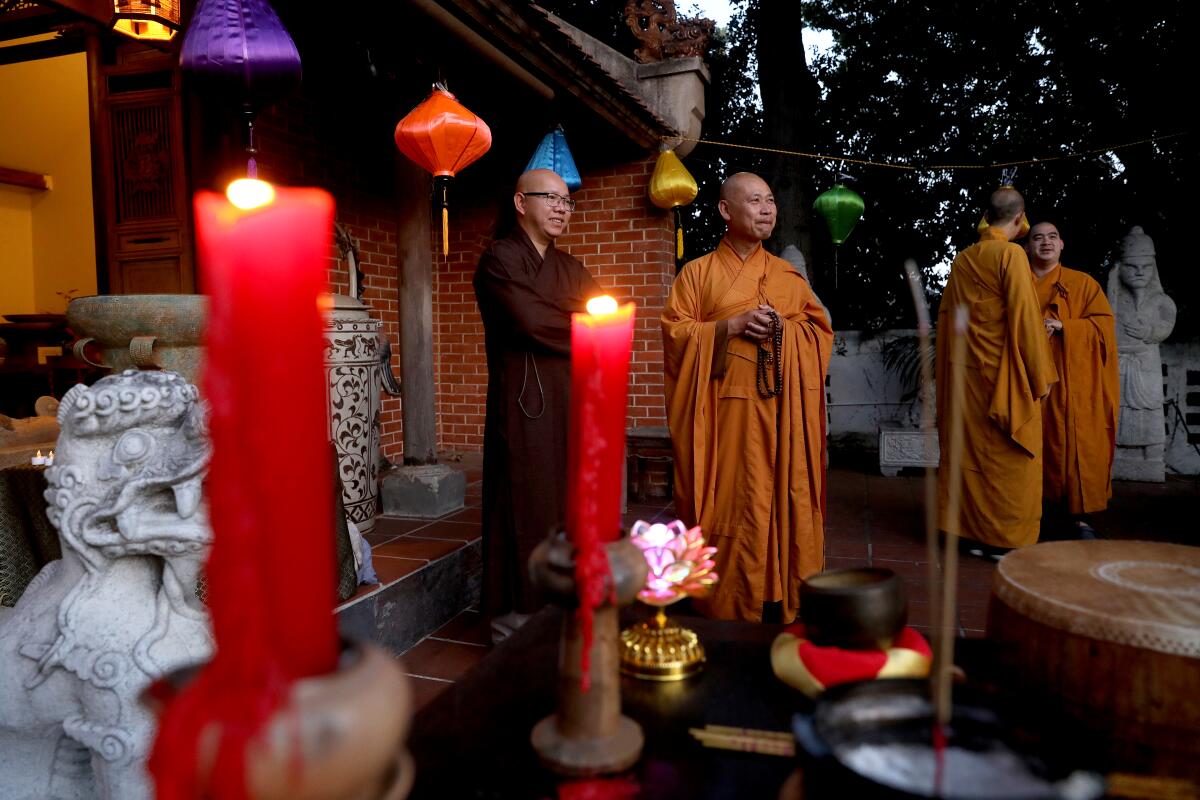 Buddhist monks before a candlelight vigil.