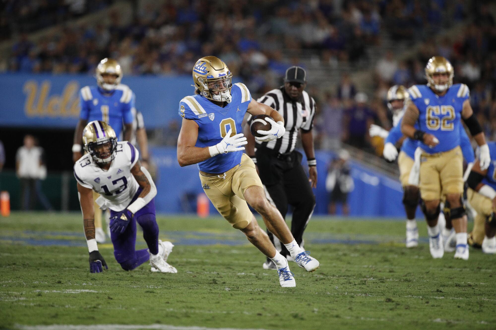 UCLA wide receiver Jake Bobo runs with the ball after making a catch during a win over Washington.
