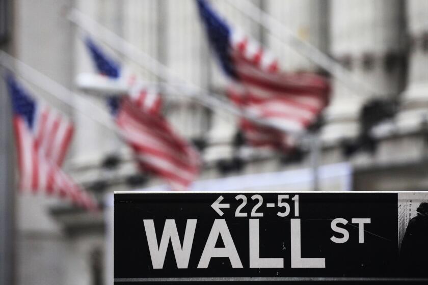 A sign marks Wall Street near the New York Stock Exchange.