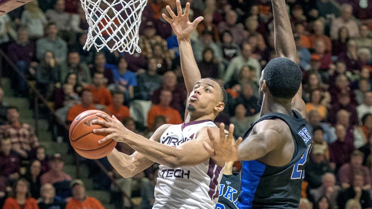 Virginia Tech guard Justin Robinson tries to score on a layup against Duke forward Amile Jefferson during the second half Saturday