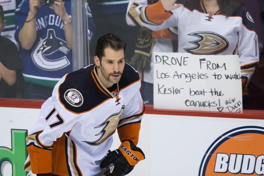 Ducks' Ryan Kesler skates past a supportive fan holding a sign before his first game against his former team, the Canucks, on Thursday.