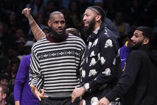 Los Angeles Lakers forward LeBron James, left, and forward Anthony Davis look on from the bench during the second half of an NBA basketball game against the Brooklyn Nets, Monday, Jan. 30, 2023, in New York. (AP Photo/Corey Sipkin)