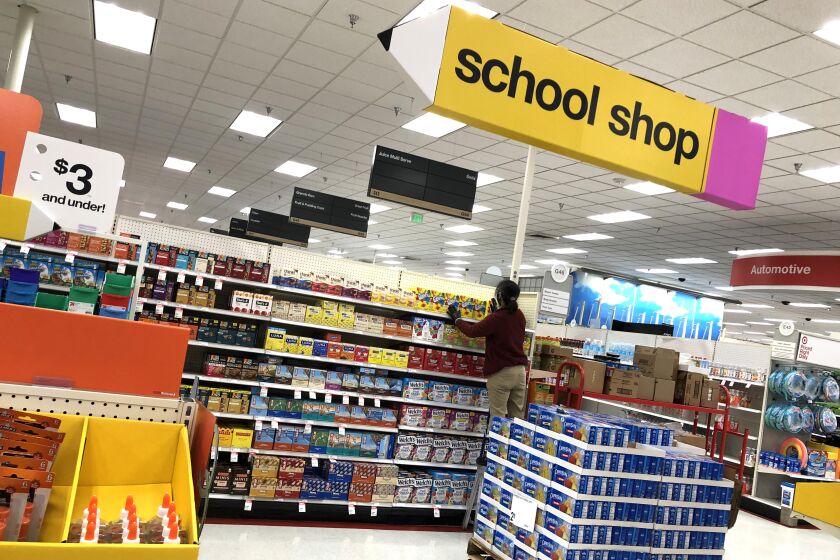 COLMA, CALIFORNIA - AUGUST 03: A worker stocks shelves of back-to-school supplies at a Target store on August 03, 2020 in Colma, California. In the midst of the ongoing coronavirus pandemic, back-to-school shopping has mostly moved to online sales, with purchases shifting from clothing to laptop computers and home schooling supplies. (Photo by Justin Sullivan/Getty Images)