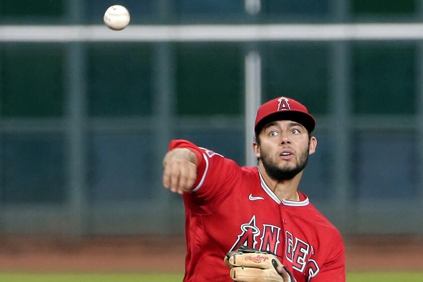 Angels second baseman David Fletcher fields a hit during a game against the Houston Astros on Aug. 24.