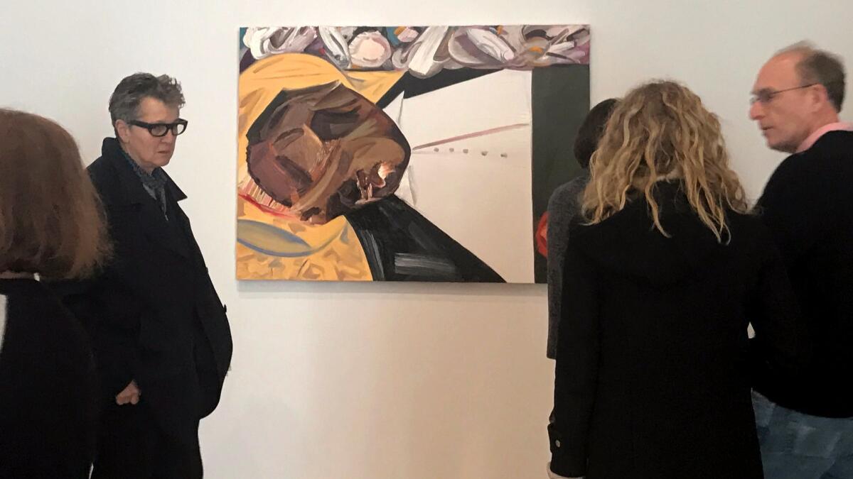 A group of museum-goers examine "Open Casket" by Dana Schutz at the Whitney Museum in March.