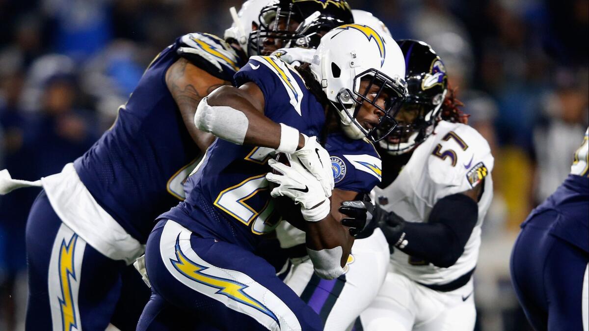 Chargers' Melvin Gordon (28) runs the ball during the first half against the Baltimore Ravens at StubHub Center on Saturday.