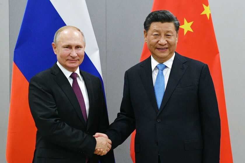 FILE - Russian President Vladimir Putin, left, and China's President Xi Jinping shake hands prior to their talks on the sideline of the 11th edition of the BRICS Summit, in Brasilia, Brazil in Nov. 12, 2019. Amid the soaring tensions over Ukraine, President Vladimir Putin is heading to Beijing on a trip intended to help strengthen Russia's ties with China and coordinate their policies amid Western pressure. (Ramil Sitdikov, Sputnik, Kremlin Pool Photo via AP, File)